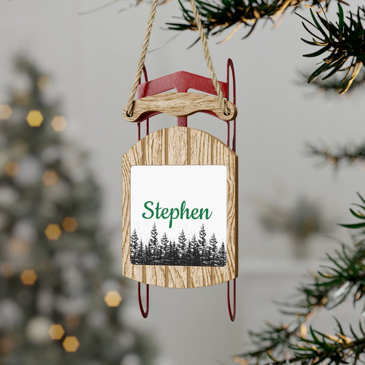 A sample image of sled ornament with forest illustration and personalized  name for Stephen hanging on a Christmas tree.